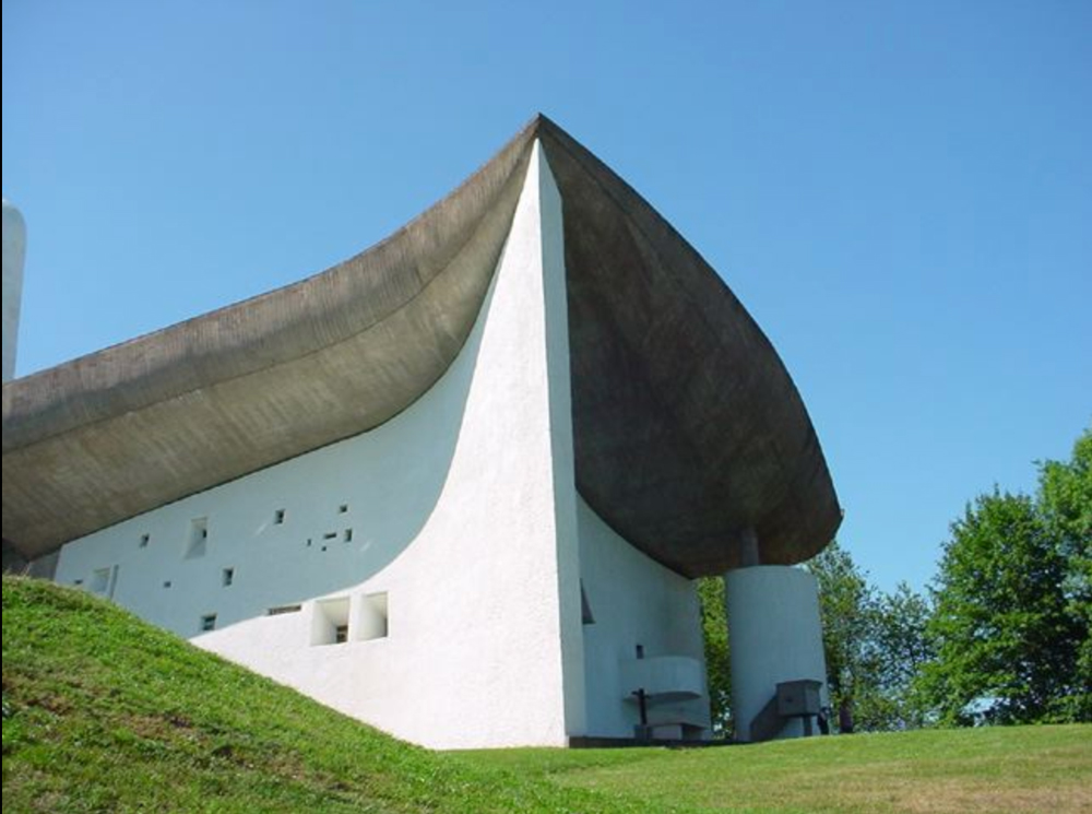 corbusier church in Ronchamp France with distinctive thatched roof 