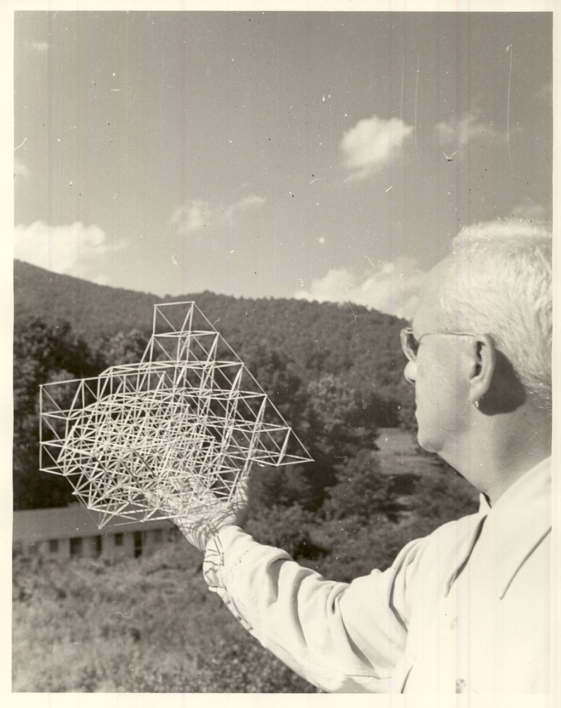 Buckminster Fuller holding object looking out towards the mountains in north carolina