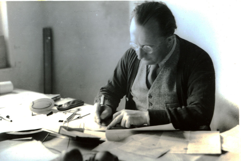 architect erich mendelsohn writing at a desk