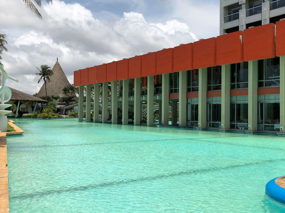 hotel d'ivoire pool and side view of hotel