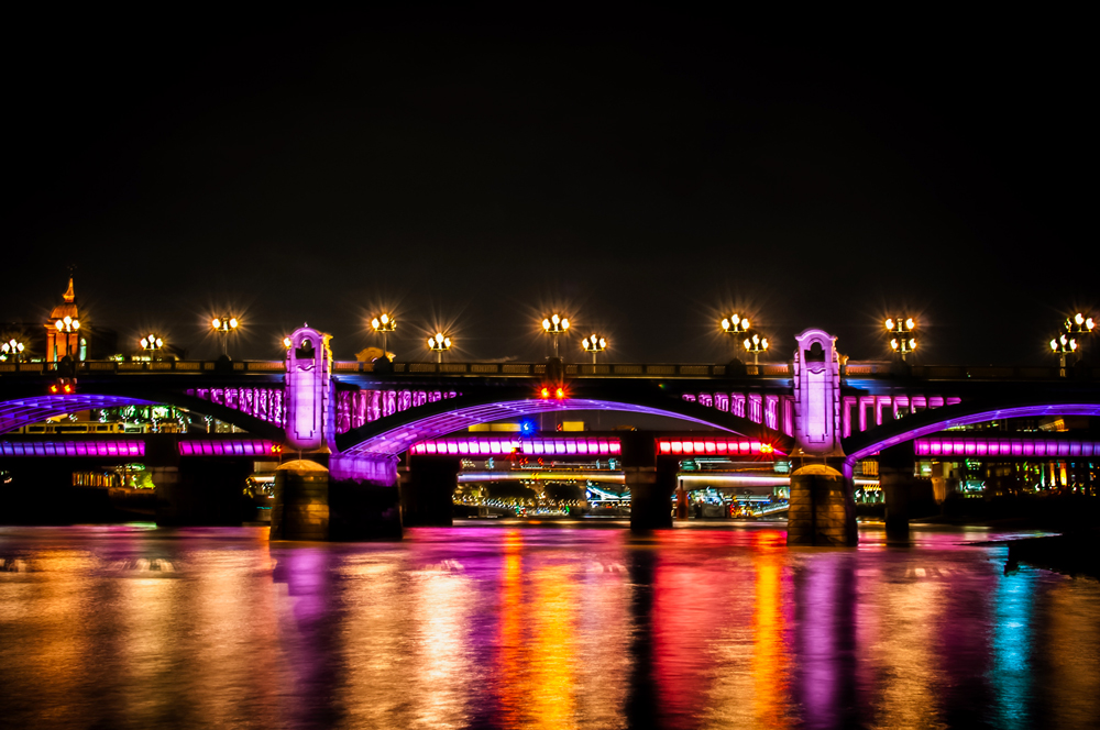 bridge over thames lit at night