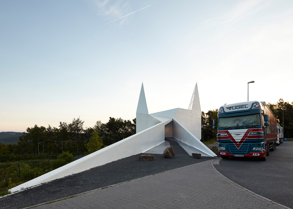 lorry parked next to autobahn church in Germany