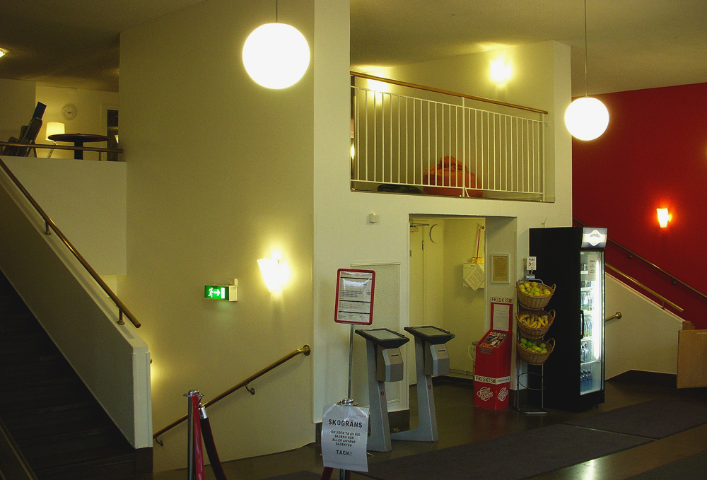 International style cinema interior with orb lights on and view to staircase