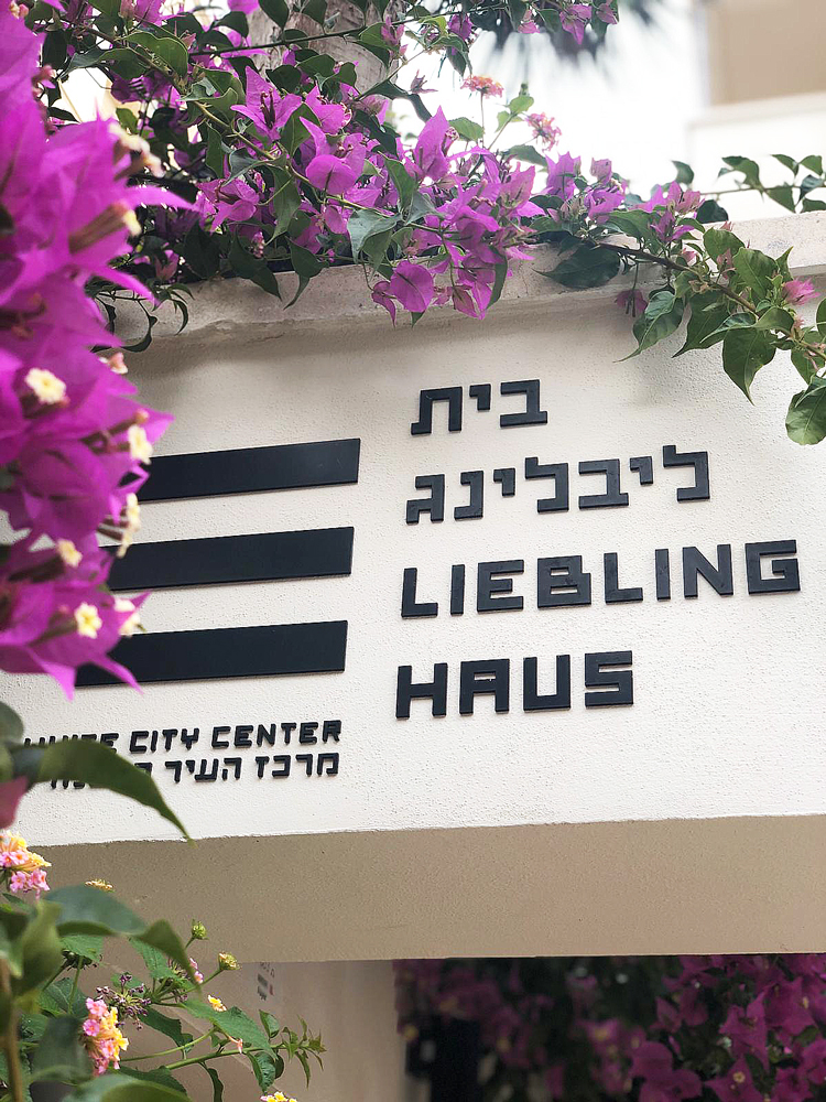 black lettering on white of Liebling Haus with flowers 