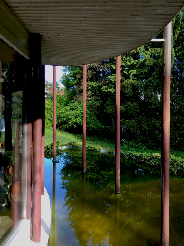 view of cylinder house from outside with water present 