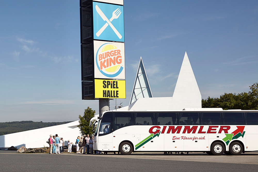 view of church with a coach parked in front