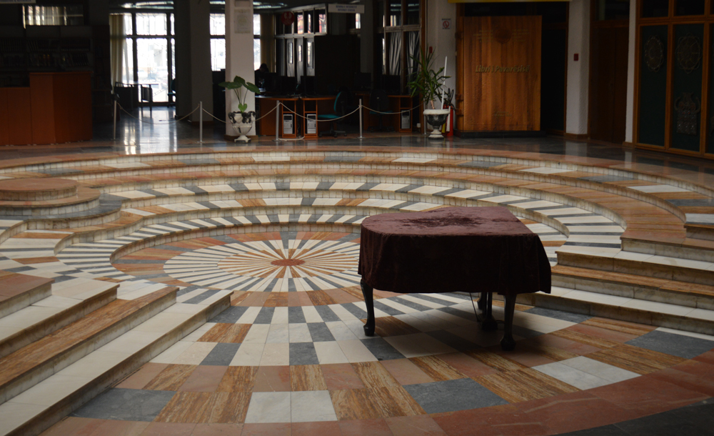 hall with detailed wooden floor and piano