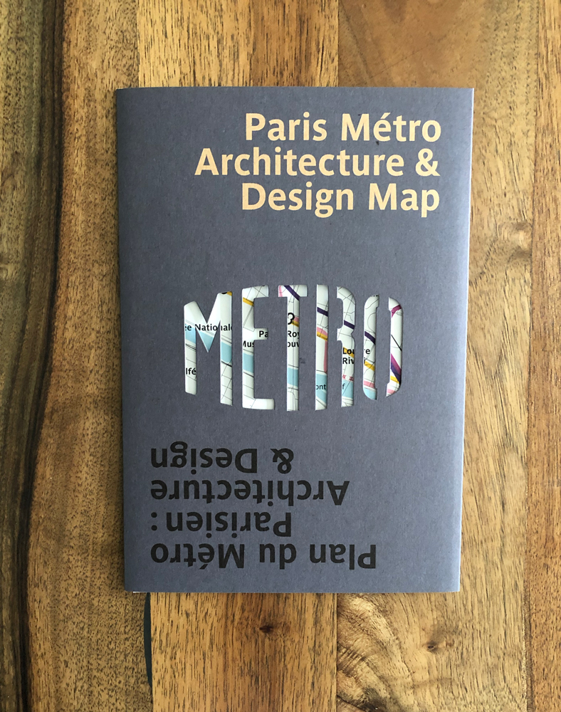 grey sleeve of paris architecture map with cut out showing through to map
