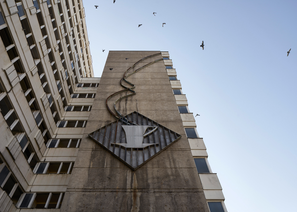 Facade of haus der statistik with coffee cup logo on side of building 