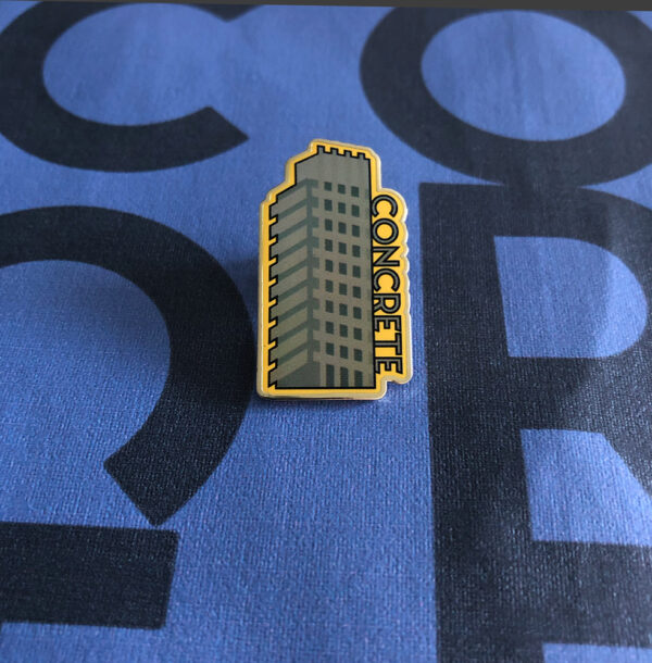 grey metal badge with yellow background with word concrete graphic design of barbican