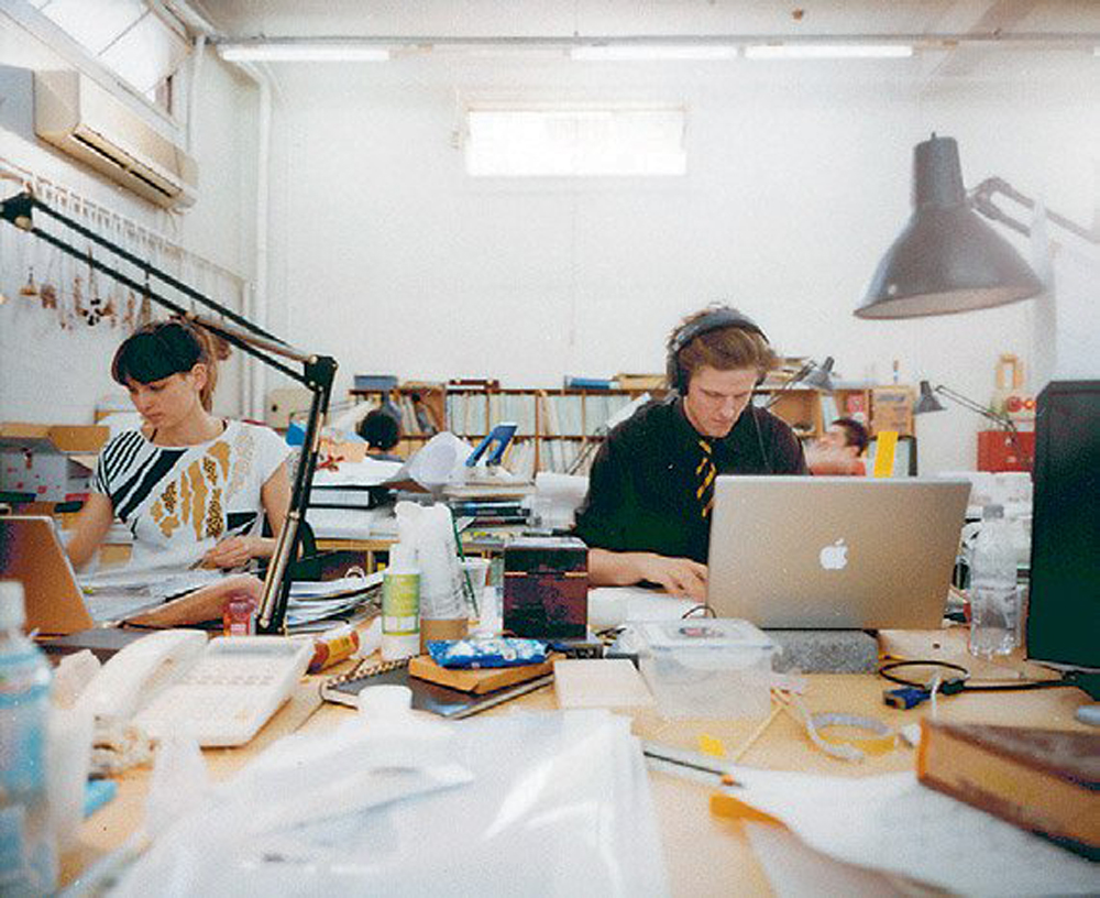 Sam and Johanna Chermayeff at their desks 