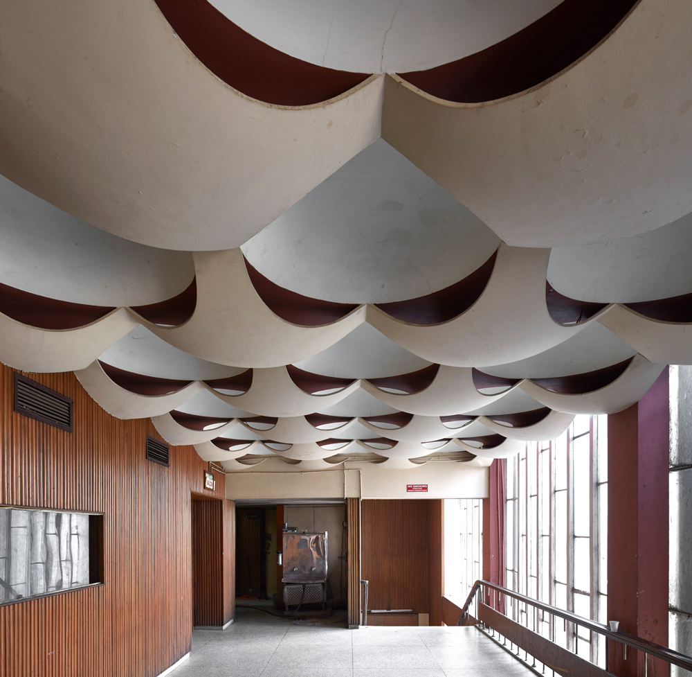 Light floods in illuminating the unique scalloped ceiling of a vestibule to the auditorium of the Neelam Theatre in Chandigarh