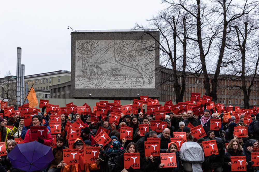 protestors holding red signs with letter Y