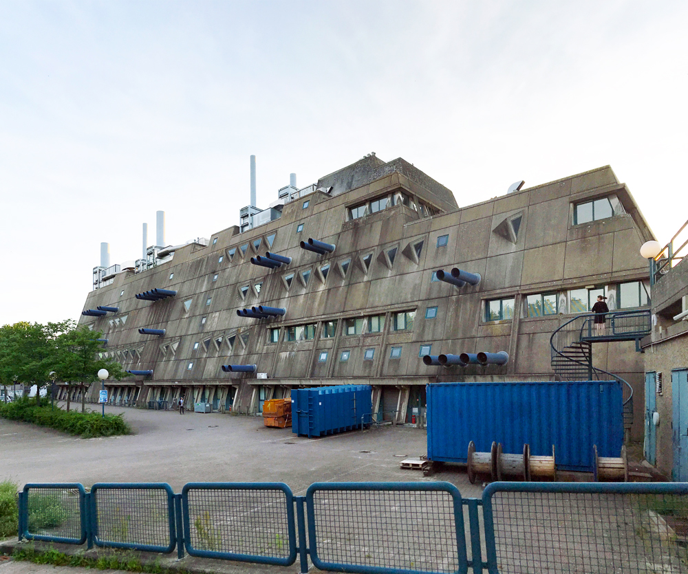 View of brutalist berlin building the mausebunker showing pipes protruding from side