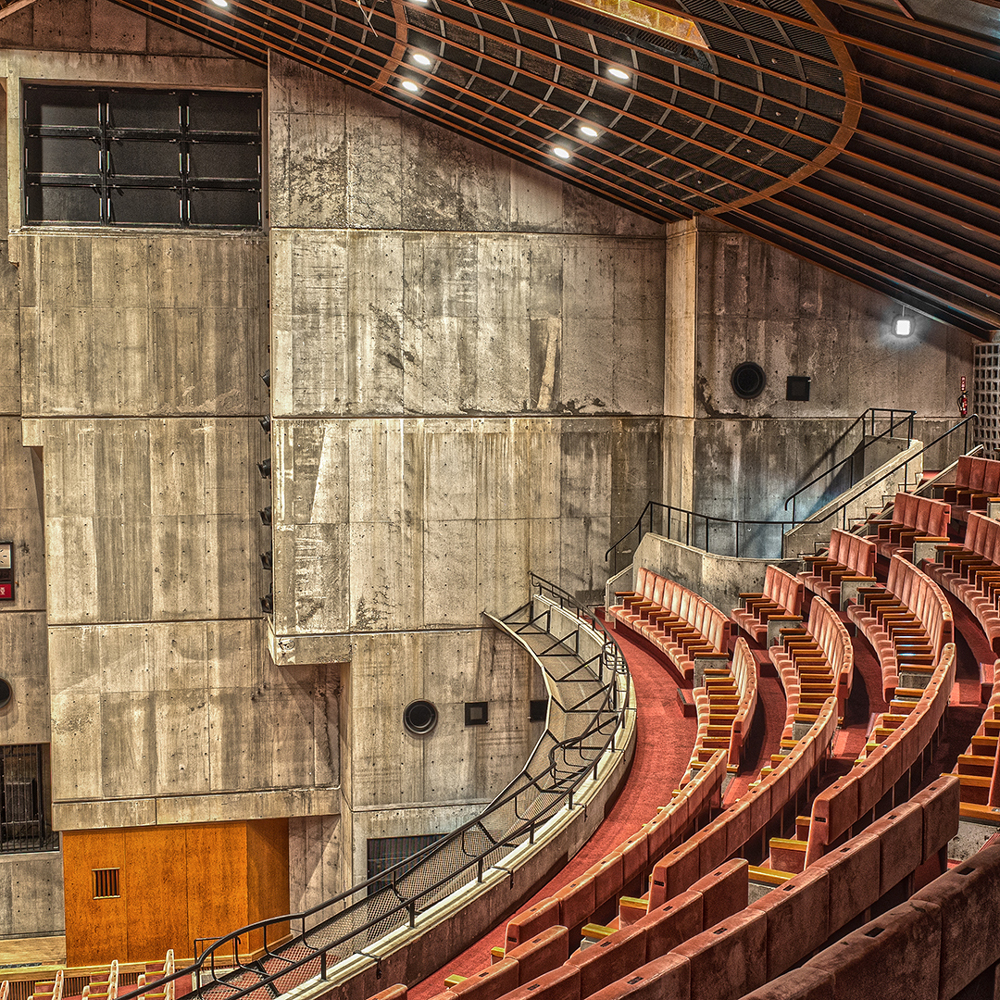 interior of civic hall with orange seating system