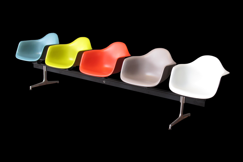 series of moulded eames chairs on one frame