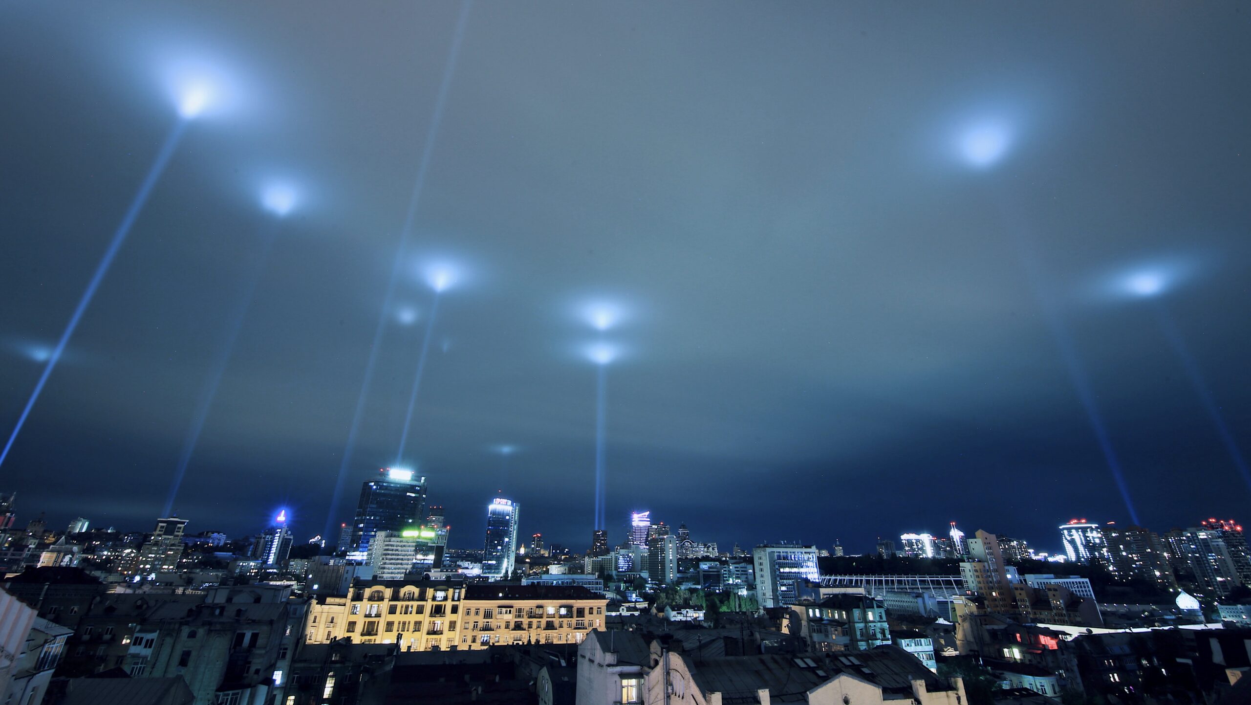 light beams into night sky over kyiv