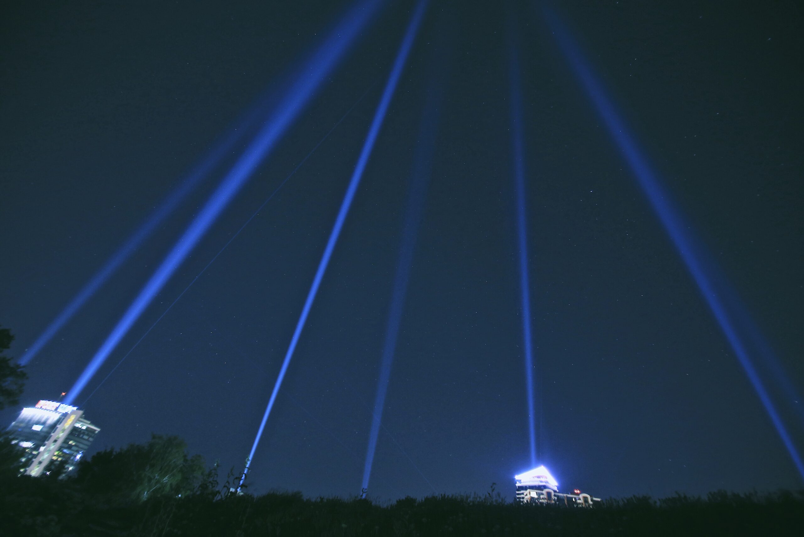 light beams into night sky over kyiv