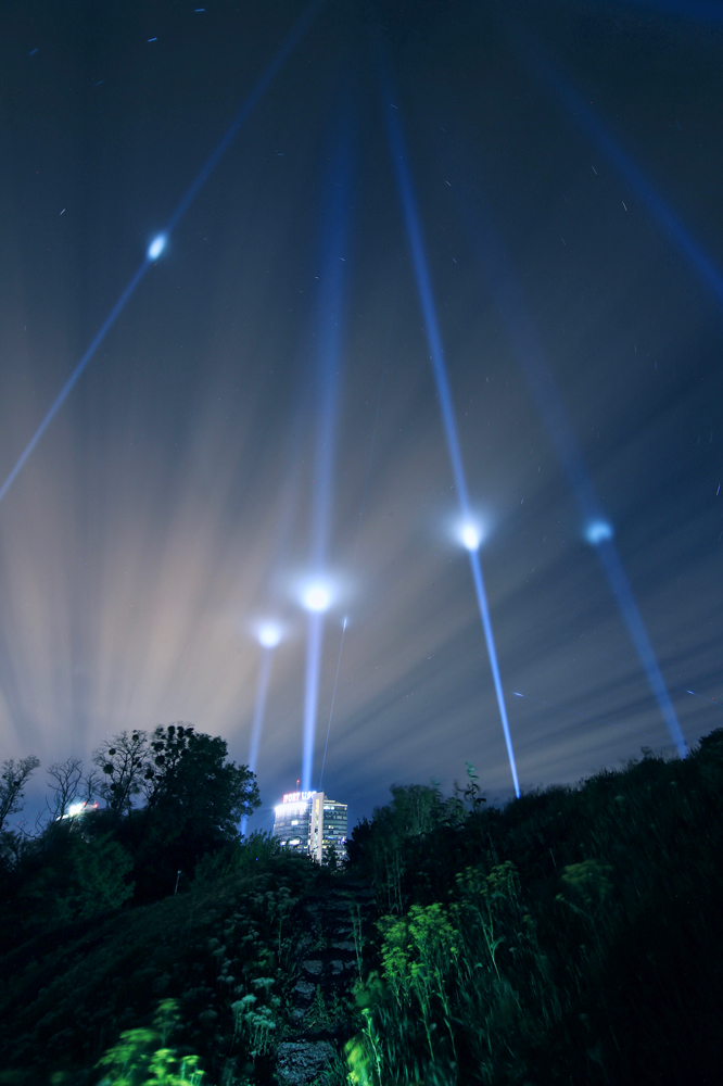 light beams into night sky over kyiv