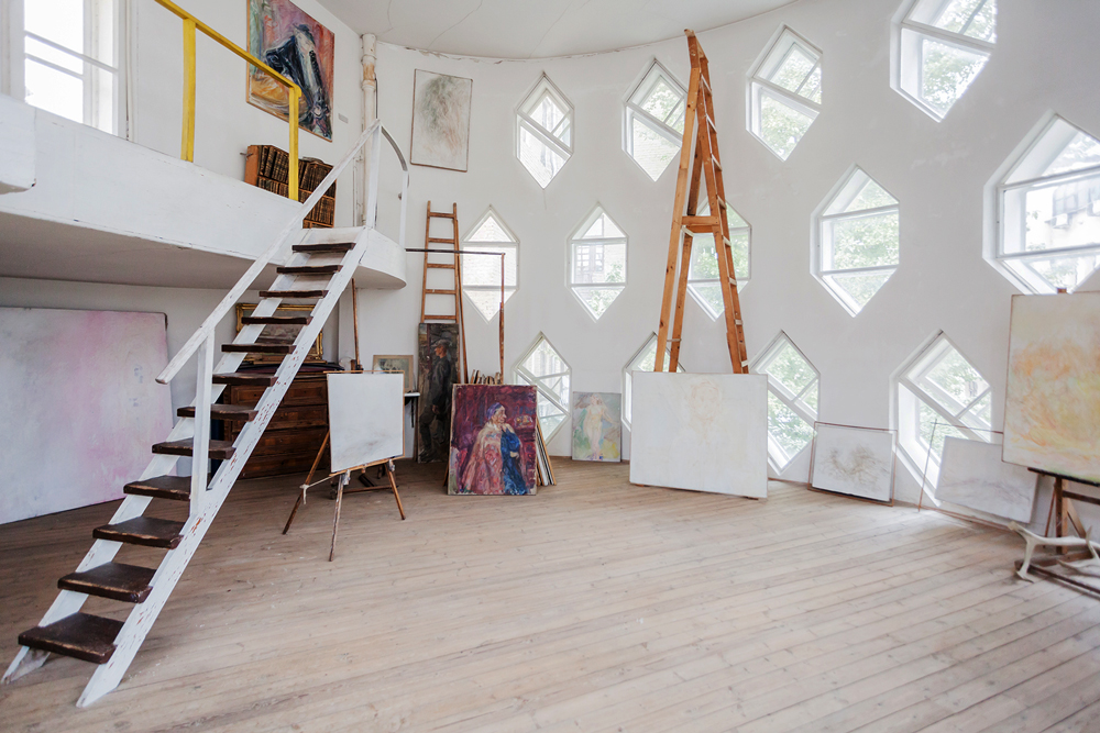Artist's studio on the upper floor of the Melnikov House with stairs up to gallery leading to exit on to the roof terrace