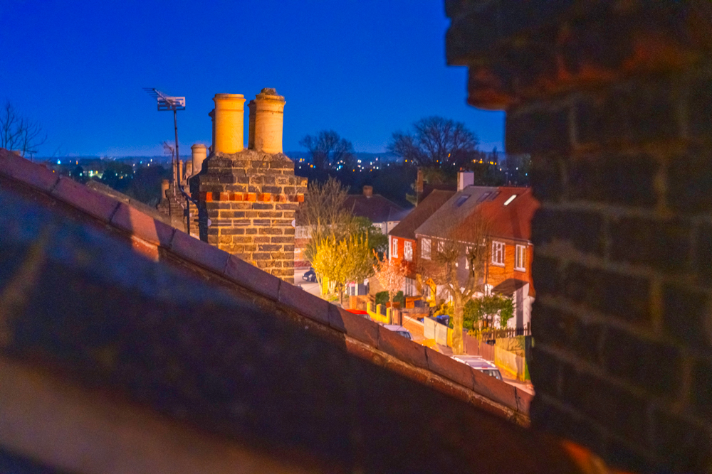 bright blue night sky over rooftops