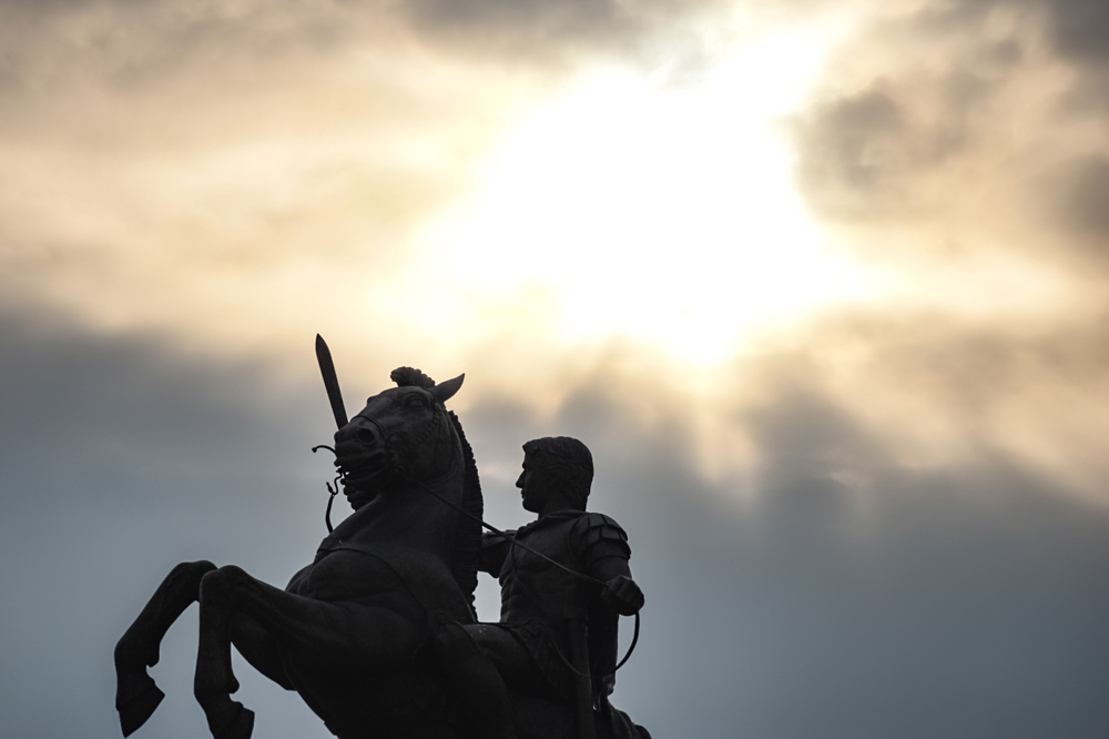 Alexander sculpture in Skopje against a setting sun