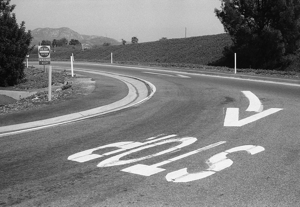 stop sign on road exiting from freeway